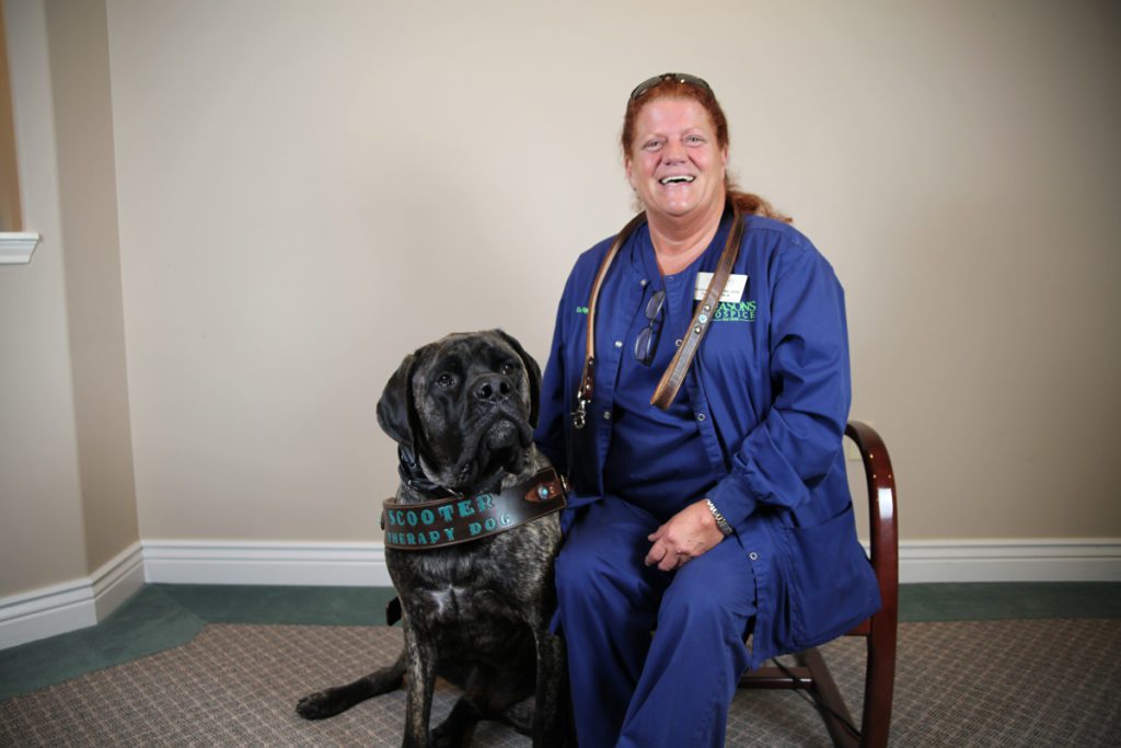 Seasons Hospice Nurse with a therapy animal